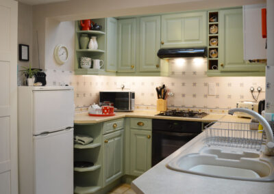 Photo: Well equipped kitchen with microwave, gas hob & electric oven